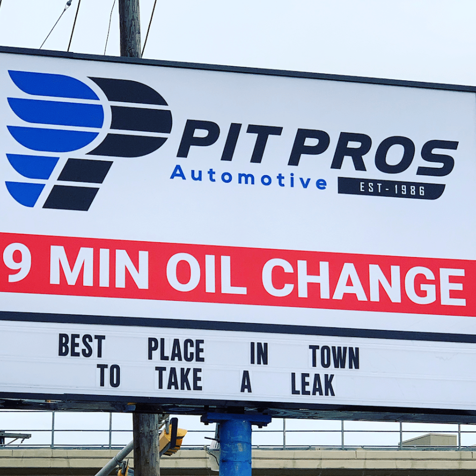 Pit Pros Automotive Dallas sign promoting fast oil change service