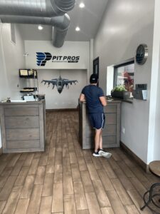 Home 4 Pit Pros Automotive service reception area with customer checking in at the counter.