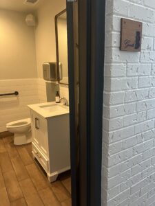 Home 7 Glance of the renovated bathroom at Pit Pros Automotive in Dallas.