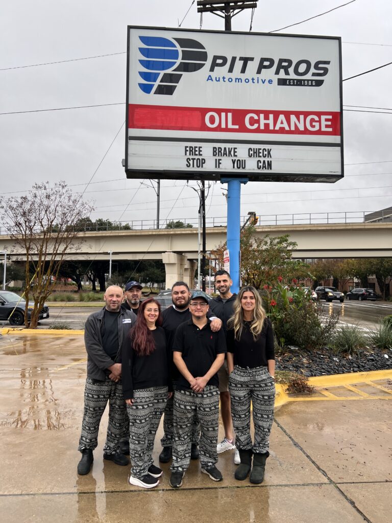 Home 8 The Pit Pros Automotive team outside the shop on Inwood Road